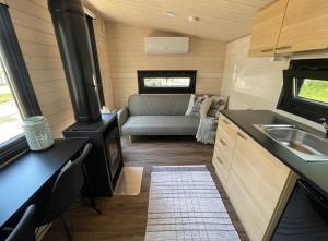 a kitchen and living room of a tiny house at Beach house with sauna in Hanko