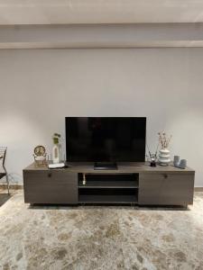 a large entertainment center with a flat screen tv at sea side in Makhinjauri