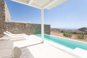 a villa with a pool and a view at The Ammonite Resort in Super Paradise Beach