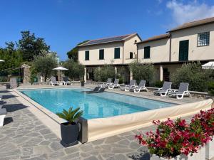 a swimming pool with chairs and a house at Il Canneto in Sestri Levante