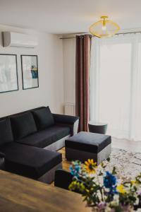 a living room with a couch and a table at Dom Goscinny Bialy Dworek in Człuch&oacute;w