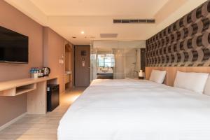 Postel nebo postele na pokoji v ubytování Guide Hotel Taipei Fuxing North