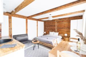 a bedroom with a bed and a dining table at WILLOW in Pāvilosta