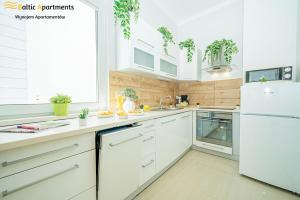 Kuchyň nebo kuchyňský kout v ubytování Baltic Apartments - Willa Carmen