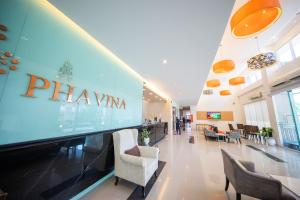 a lobby of a pharmacy with chairs and tables at Phavina Hotel Rayong SHA Extra Plus in Rayong