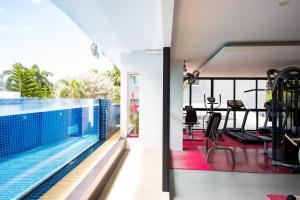 a house with a swimming pool and a gym at Phavina Hotel Rayong SHA Extra Plus in Rayong