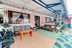 a living room with couches and a table at Hotel New Dieng By Helocus in Berastagi