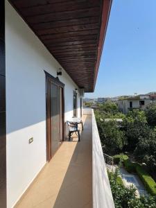a balcony of a house with a table on it at Armando's wooden roof in Berat