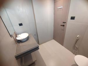 a bathroom with a sink and a toilet at Hotel Gagan Suite in Kānpur
