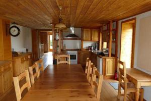 a kitchen with a long wooden table and chairs at Les hauts de Saint Christaud in Pallanne