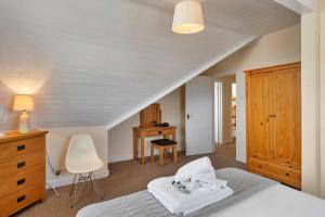 a bedroom with a bed and a desk and a chair at Finest Retreats - No 11 Porthminster in St Ives
