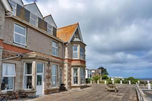 a large brick building with a picnic table in front of it at Finest Retreats - No 11 Porthminster in St Ives