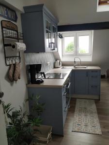 a small kitchen with a sink and a stove at Ferienwohnung Luna in Trier
