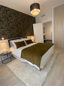 a bedroom with a large bed and a rug at Montana Bussy Saint Georges in Bussy-Saint-Georges
