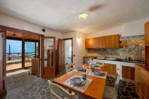 a kitchen with a table and a dining room at Casa Allegra in Praiano