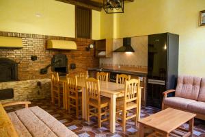 uma cozinha e sala de jantar com mesa e cadeiras em El Horno de Leopoldo em Hueva