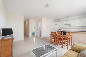 a living room and kitchen with a couch and a table at Isla 1 in San Isidro +12 photos