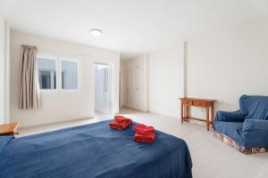 a bedroom with a blue bed and a blue chair at Isla 1 in San Isidro