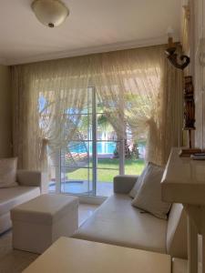 a living room with a couch and a large window at Villa B&D in Fethiye +23 photos