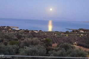 a view of the ocean with the moon in the sky at Κτήμα Καστέλι in Paralia Demonias