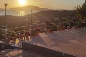 a view of the sun setting over the water at Κτήμα Καστέλι in Paralia Demonias +9 photos