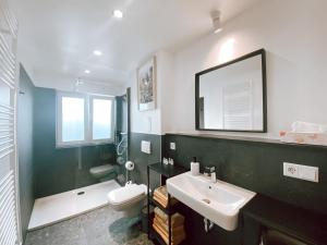 a bathroom with a sink and a toilet and a mirror at BetterBeds Berlin in Berlin +18 photos