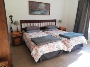 two beds sitting next to each other in a room at Sheeprun Farmstay in Maclear