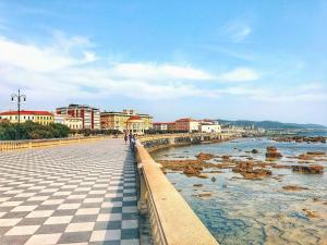 a bridge over the water with buildings and a city at Eleganza Marina in Livorno