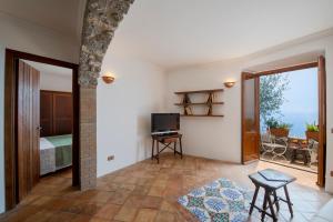 a living room with a room with a bed and a window at Casa Allegra in Praiano