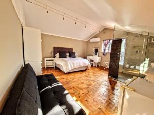 a living room with a bed and a couch at 9 on Drommedaris in Stellenbosch +69 photos
