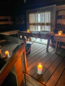 a room with two candles on a wooden table at Pihlajaharju Countryside Escape in Somero +27 photos