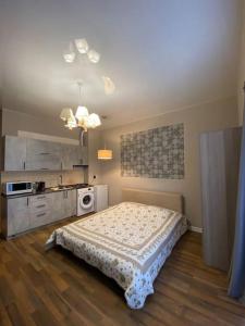 a small bedroom with a bed and a kitchen at Lusi sweet home in Batumi
