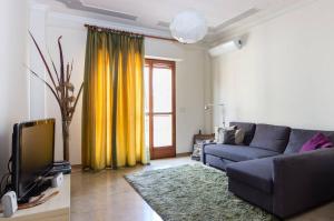 a living room with a couch and a tv at Your Room in Catania in Catania