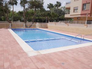 a swimming pool in the middle of a building at Malvarrosa, 1-6 in Cullera