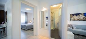 a living room with a bed and a mirror at Apartment Sandra with balcony in Split