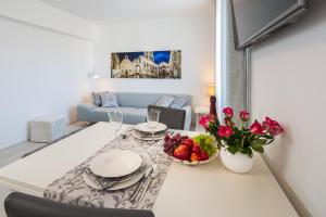 a living room with a table with a bowl of fruit at Apartment Sandra with balcony in Split