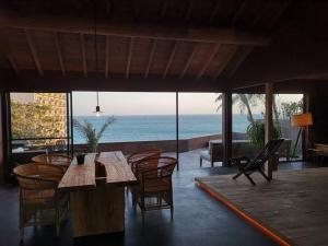 a dining room with a table and chairs and the ocean at Secret break Hebara in Katsuura