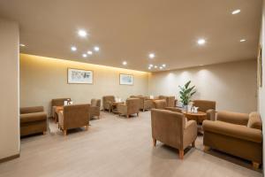 a waiting room with chairs and tables in a hospital at Lebanshan Hotel Jiuzhai Valley in Jiuzhaigou
