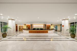 a lobby with a reception desk in a building at Lebanshan Hotel Jiuzhai Valley in Jiuzhaigou