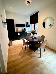 a dining room with a table and chairs in a room at Urbanchic Opéra 2B in Liège +11 photos