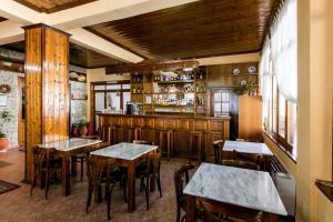 a dining room with tables and a bar at Hotel Dryades in Elati Trikalon