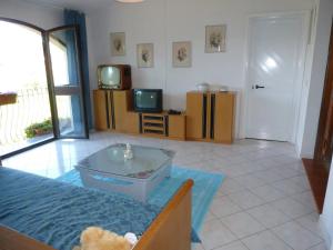 a living room with a teddy bear sitting on a bed at Suite Angelica in Iglesias