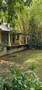 a yellow house with a porch in a yard at Debaraliyadda Estate in Pannala