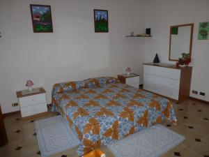a bedroom with a bed and two dressers at Suite Angelica in Iglesias
