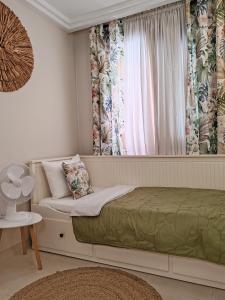 a bedroom with a bed and a window with curtains at Paula Pool Apartment Adeje in Adeje +37 photos