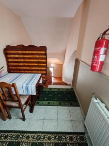 an attic room with a staircase with a fire extinguisher at Európa Apartman in Záhony