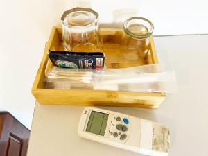 a wooden tray with a remote control on a table at Mini Homestay in Hanoi