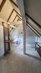 a bathroom with a glass shower in a attic at Hotel De la Paix in Luzern