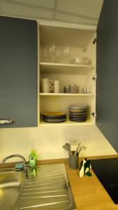 a kitchen with a sink and a counter with dishes at Eveve's House in Parma +19 photos