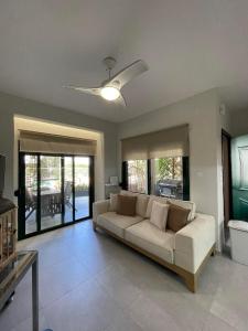a living room with a white couch and glass doors at Nikiti, four seasons house in Nikiti